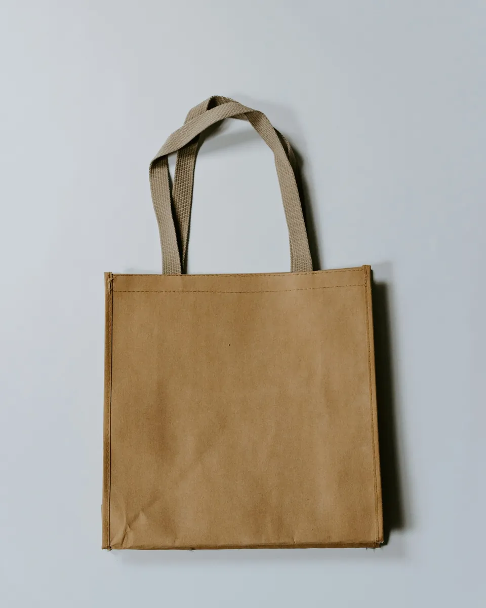 Waxed canvas tote with flat carry handles and an interior pocket