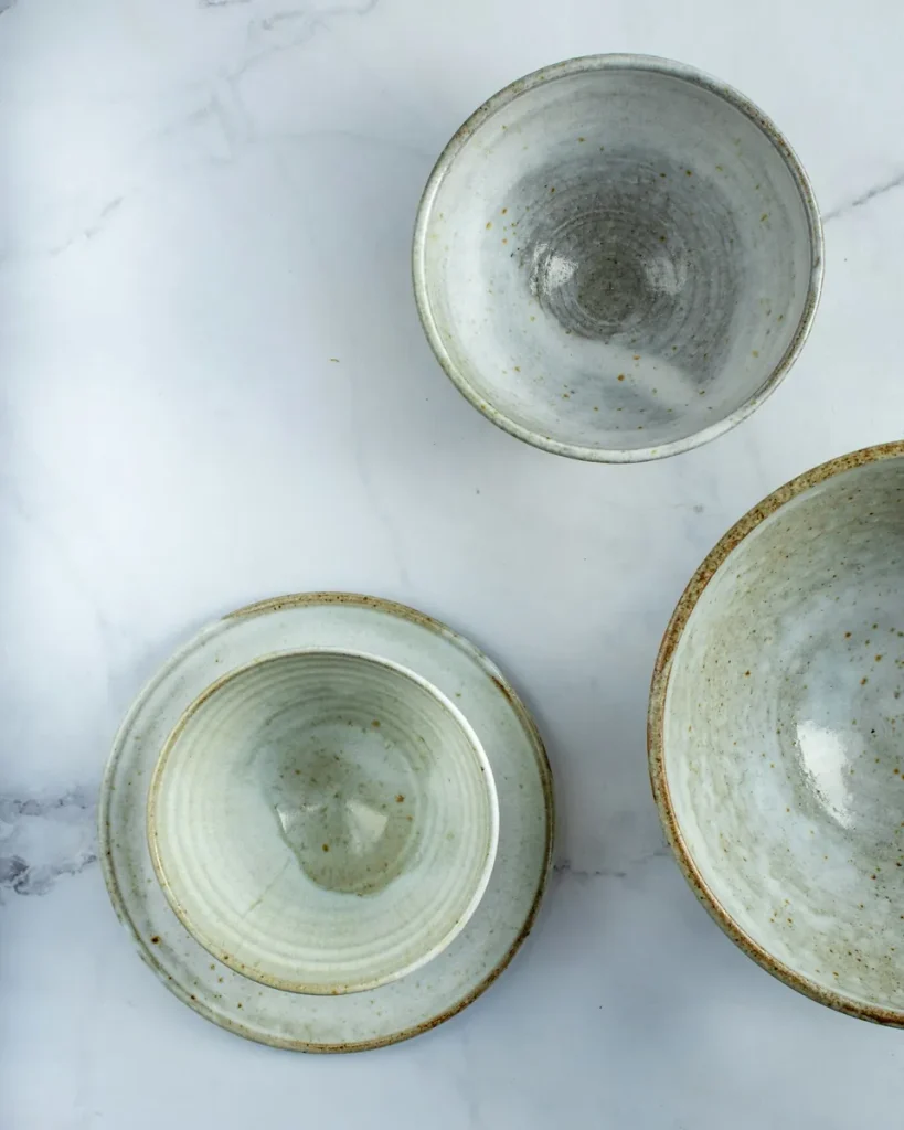 Stack of four speckled stoneware dinner plates
